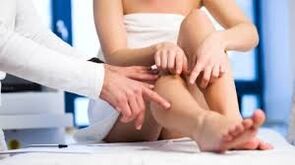 The doctor examines the patient's leg